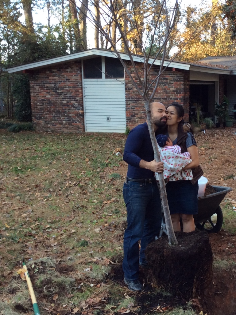 David and Jane holding Winter and his cherry tree.